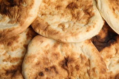 Photo of Delicious fresh pita bread as background, top view