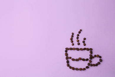 Photo of Cup made of coffee beans on lilac background, flat lay. Space for text