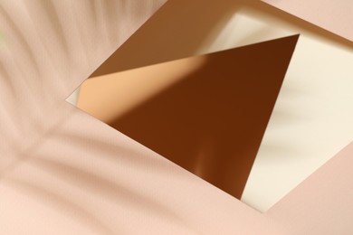 Presentation of product. Glass surface and shadows on pink background, above view