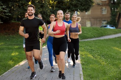 Photo of Group of people running in park. Active lifestyle