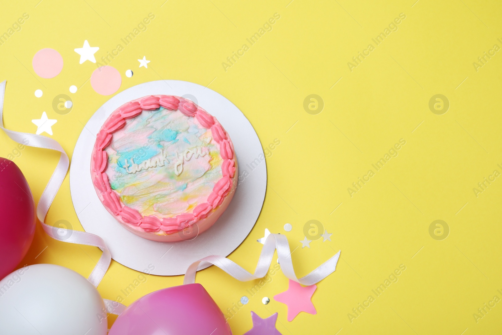 Photo of Cute bento cake with tasty cream and decor on yellow background, flat lay. Space for text