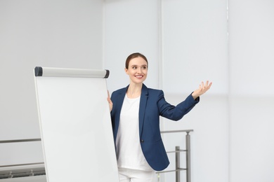 Photo of Professional business trainer near flip chart board indoors. Space for text