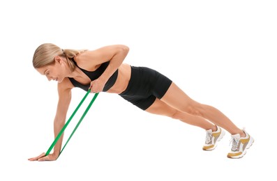 Woman exercising with elastic resistance band on white background