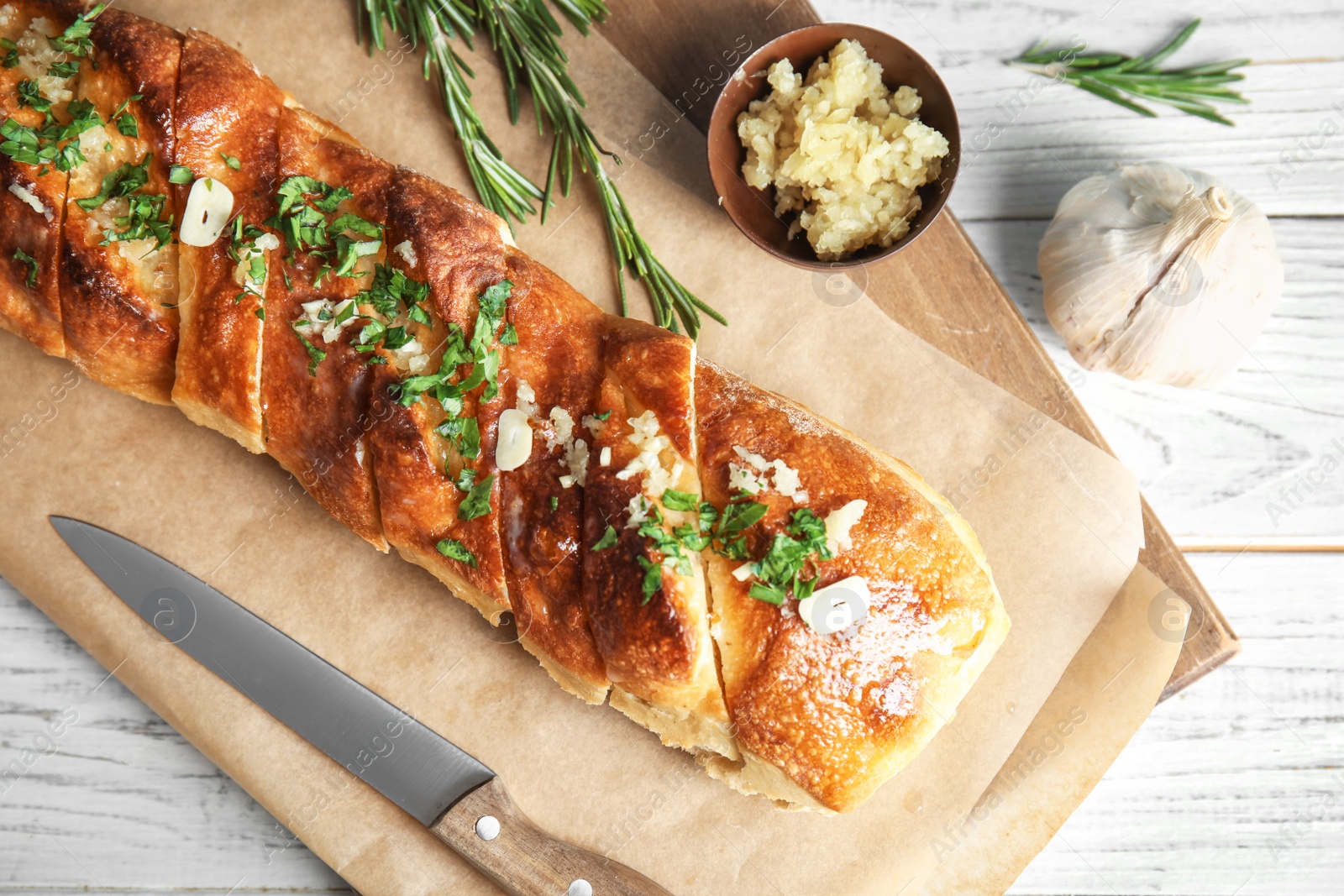 Photo of Flat lay composition with tasty homemade garlic bread on table