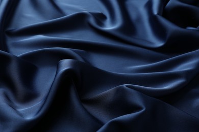 Texture of blue crumpled silk fabric as background, closeup