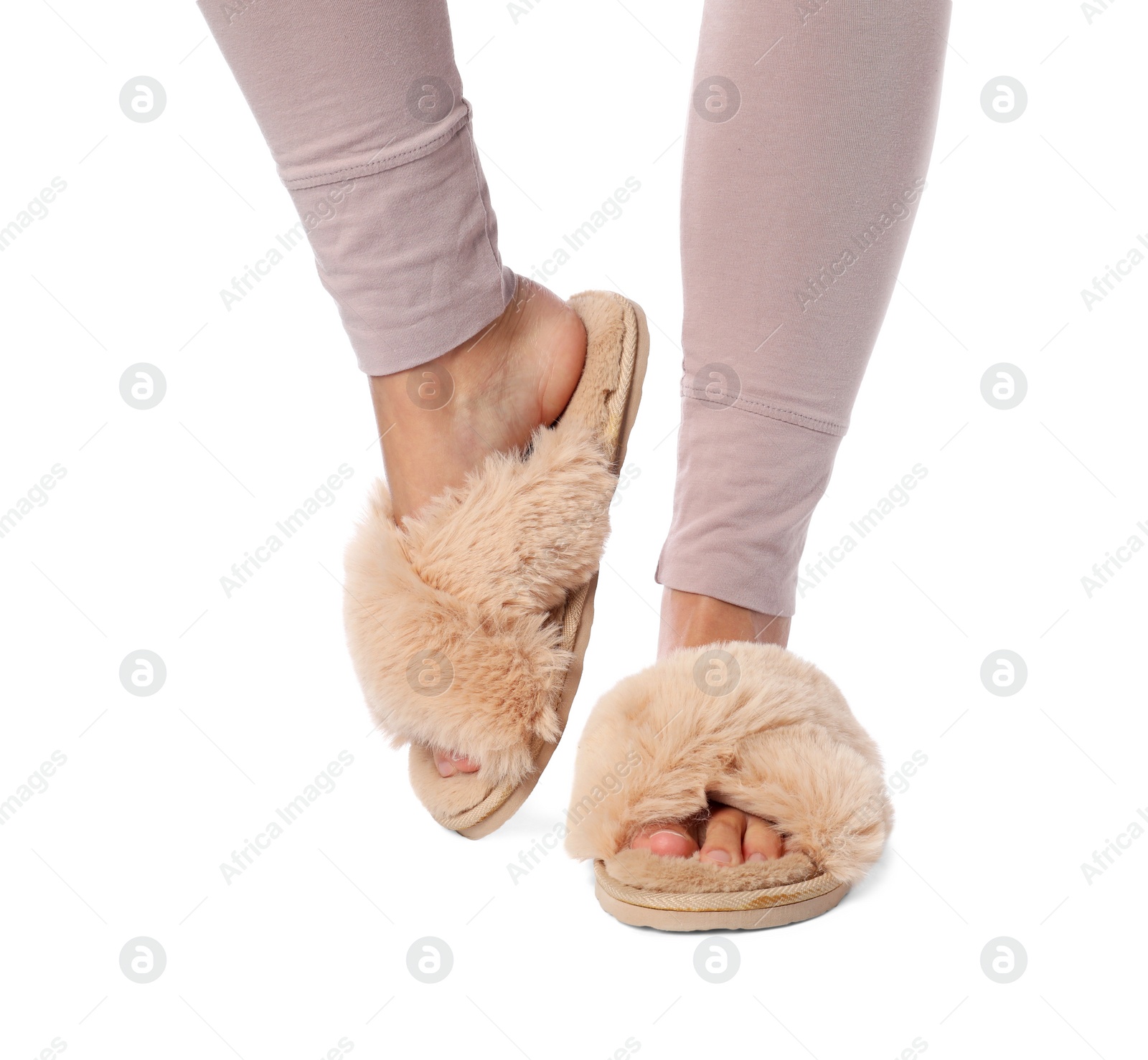 Photo of Woman in beige fluffy slippers on white background, closeup