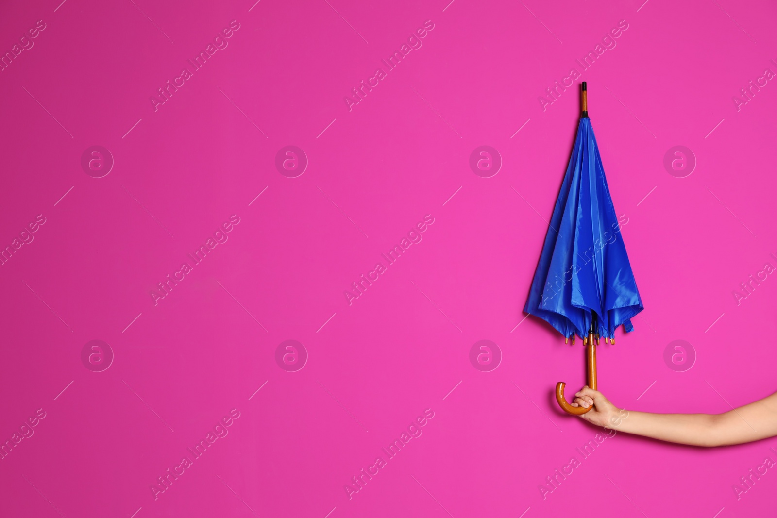 Photo of Woman holding beautiful umbrella on color background with space for design