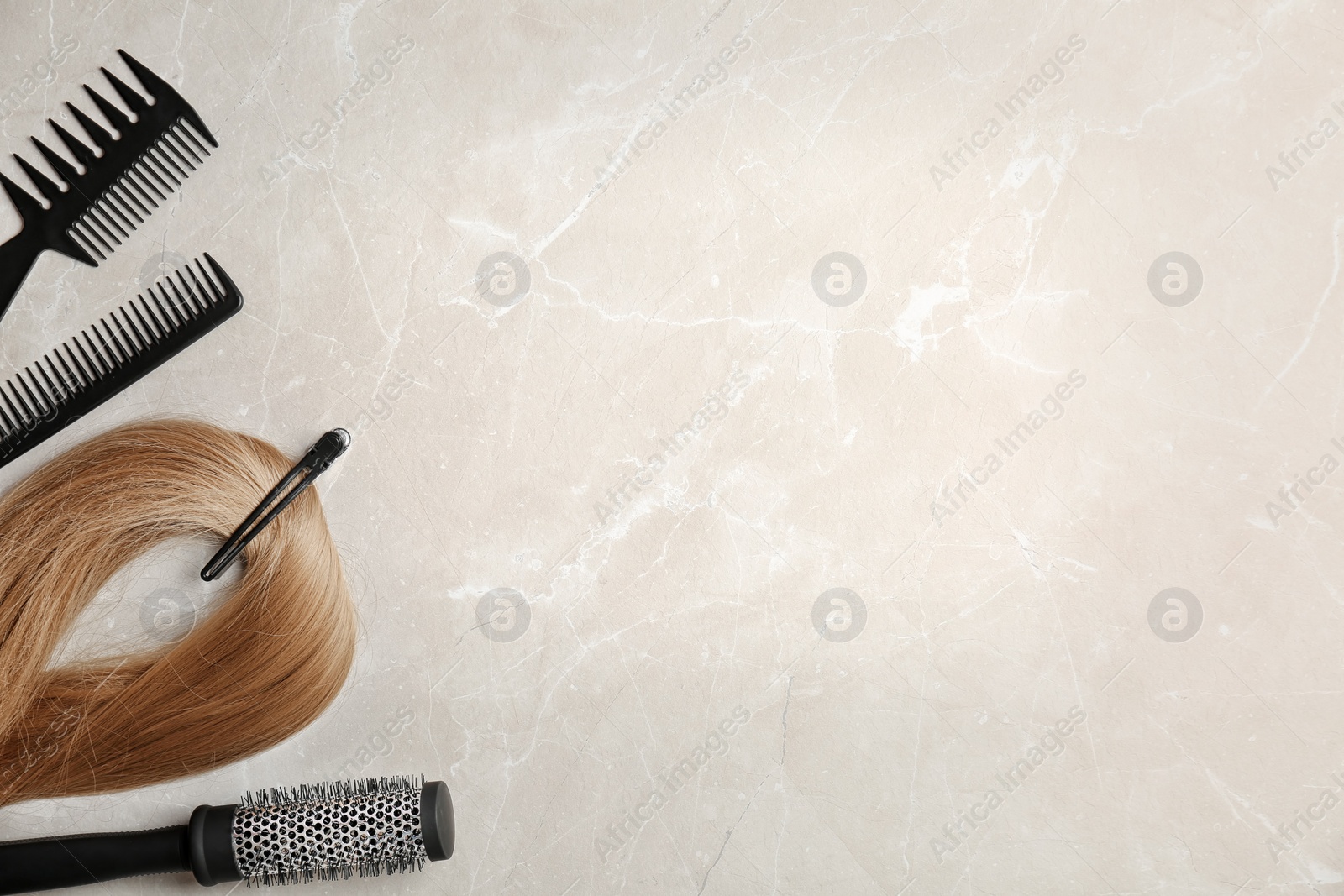 Photo of Flat lay composition with professional hairdresser tools on grey background