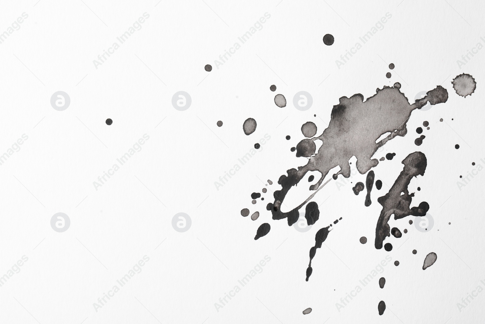 Photo of Blots of black ink on white background, flat lay. Space for text