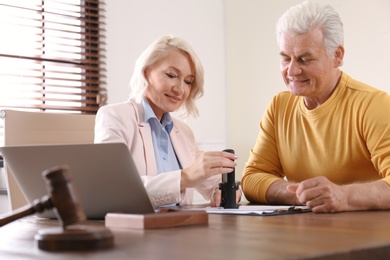 Female notary working with client in office