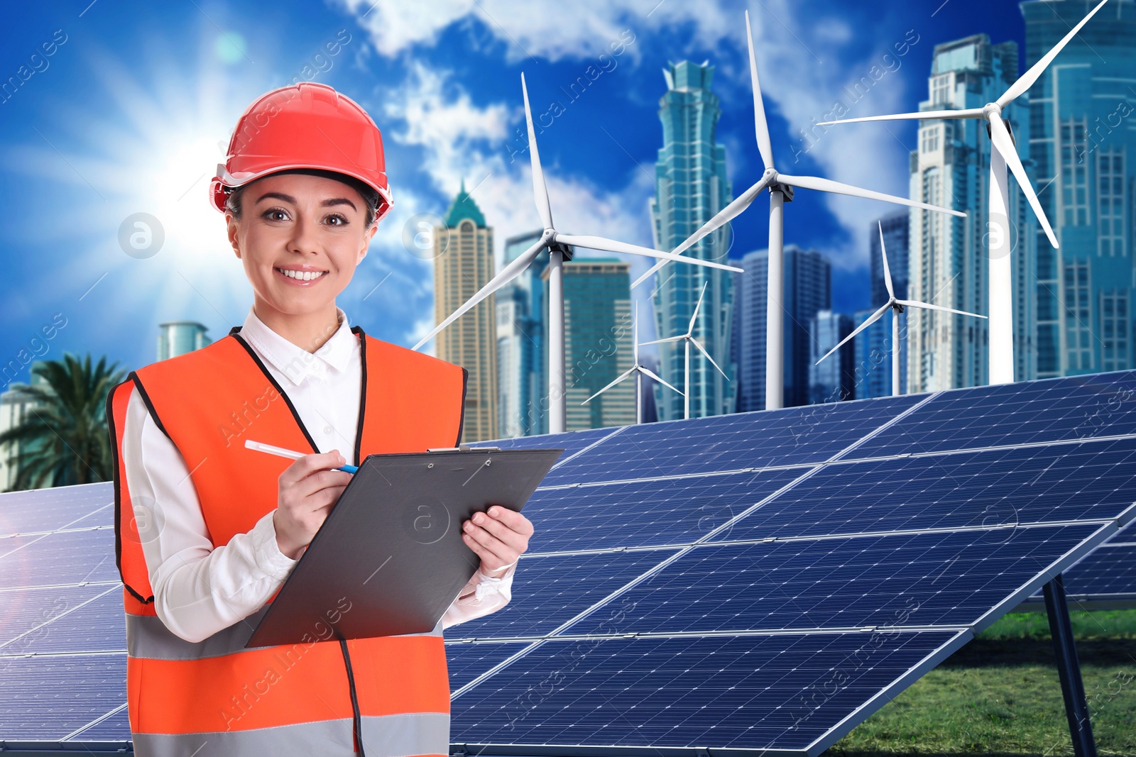 Image of Industrial engineer in uniform and view of solar panels and wind energy turbines installed outdoors