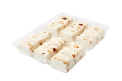 Photo of Plastic containers with pieces of nougat on white background