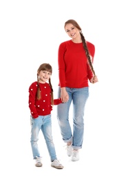 Happy woman and daughter in stylish clothes on white background