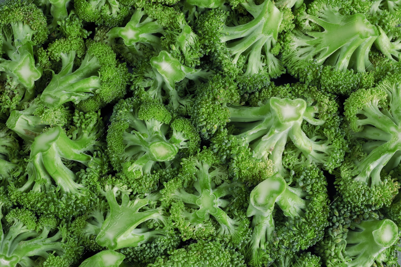 Photo of Fresh raw broccoli as background, top view