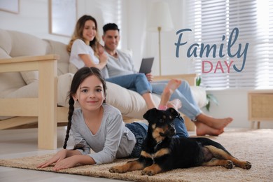 Image of Little girl with puppy lying and her parents sitting on sofa in living room. Happy Family Day