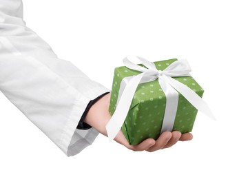 Photo of Doctor holding gift box on white background, closeup. Medical present