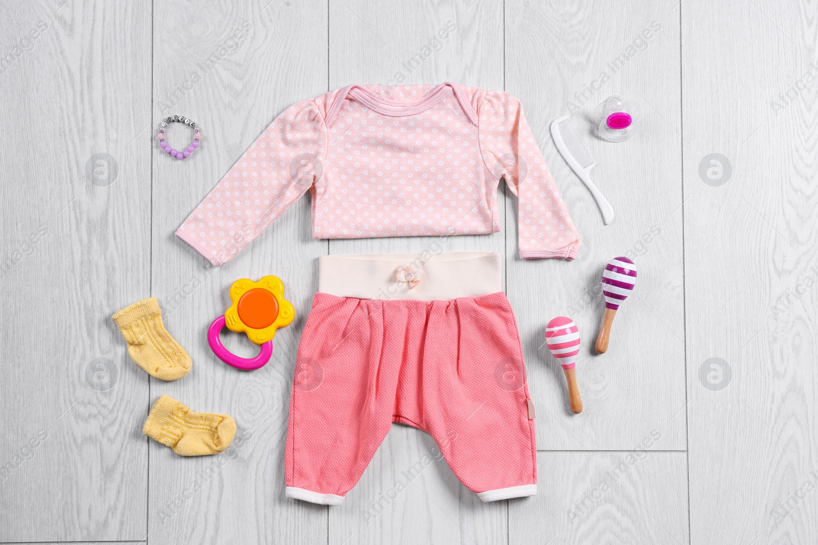 Photo of Flat lay composition with stylish child clothes and accessories on wooden background