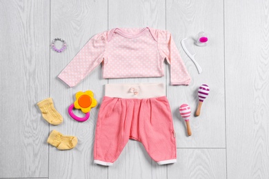 Photo of Flat lay composition with stylish child clothes and accessories on wooden background