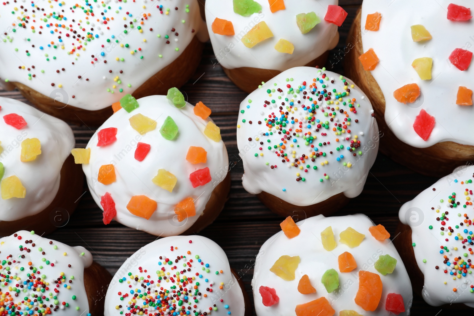 Photo of Traditional Easter cakes on wooden table, flat lay