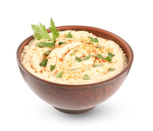 Photo of Tasty hummus with parsley and paprika in brown bowl isolated on white