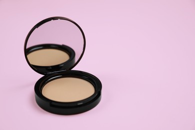 Photo of One face powder on pink background, space for text