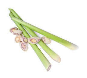 Whole and cut fresh lemongrass on white background, top view