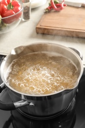 Photo of Cooking pasta in pot on electric stove