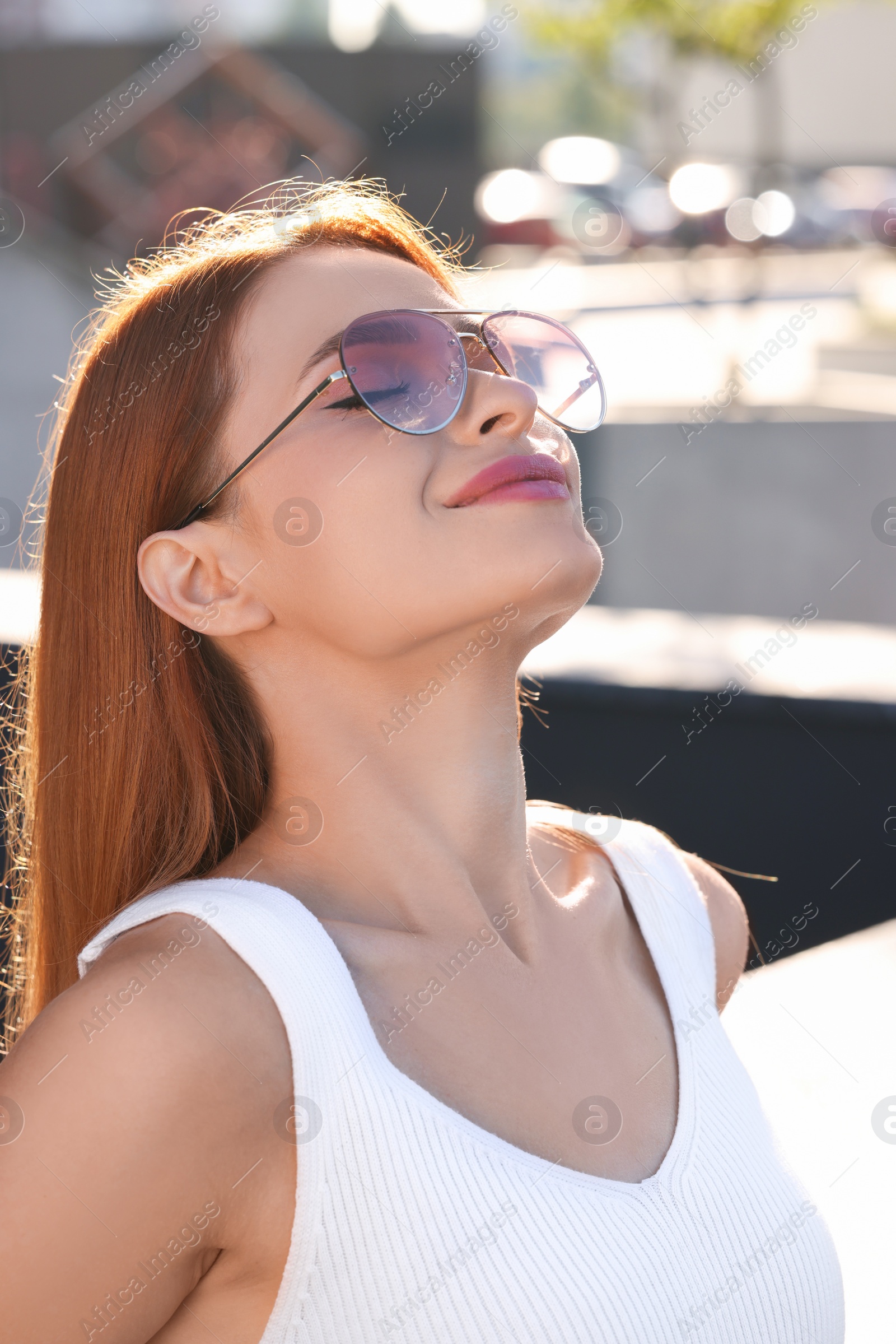 Photo of Beautiful woman in sunglasses on city street