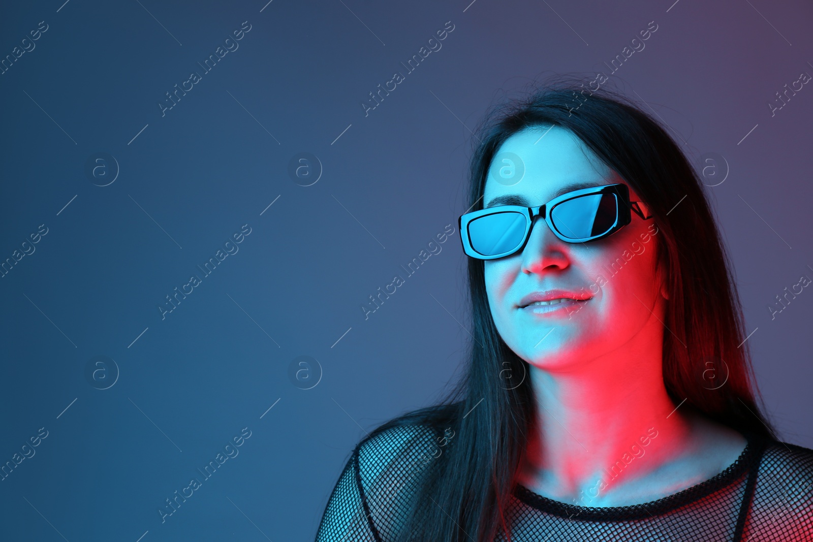 Photo of Portrait of beautiful young woman with sunglasses on color background. Space for text