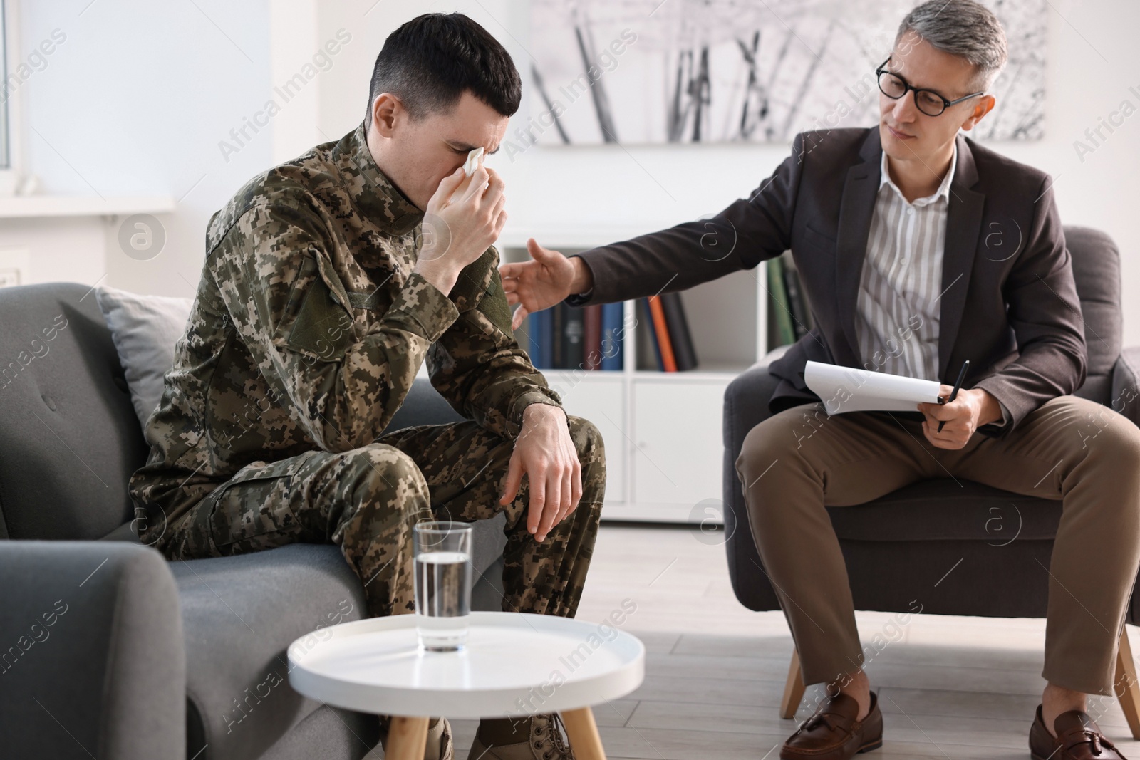 Photo of Professional psychotherapist working with military man in office