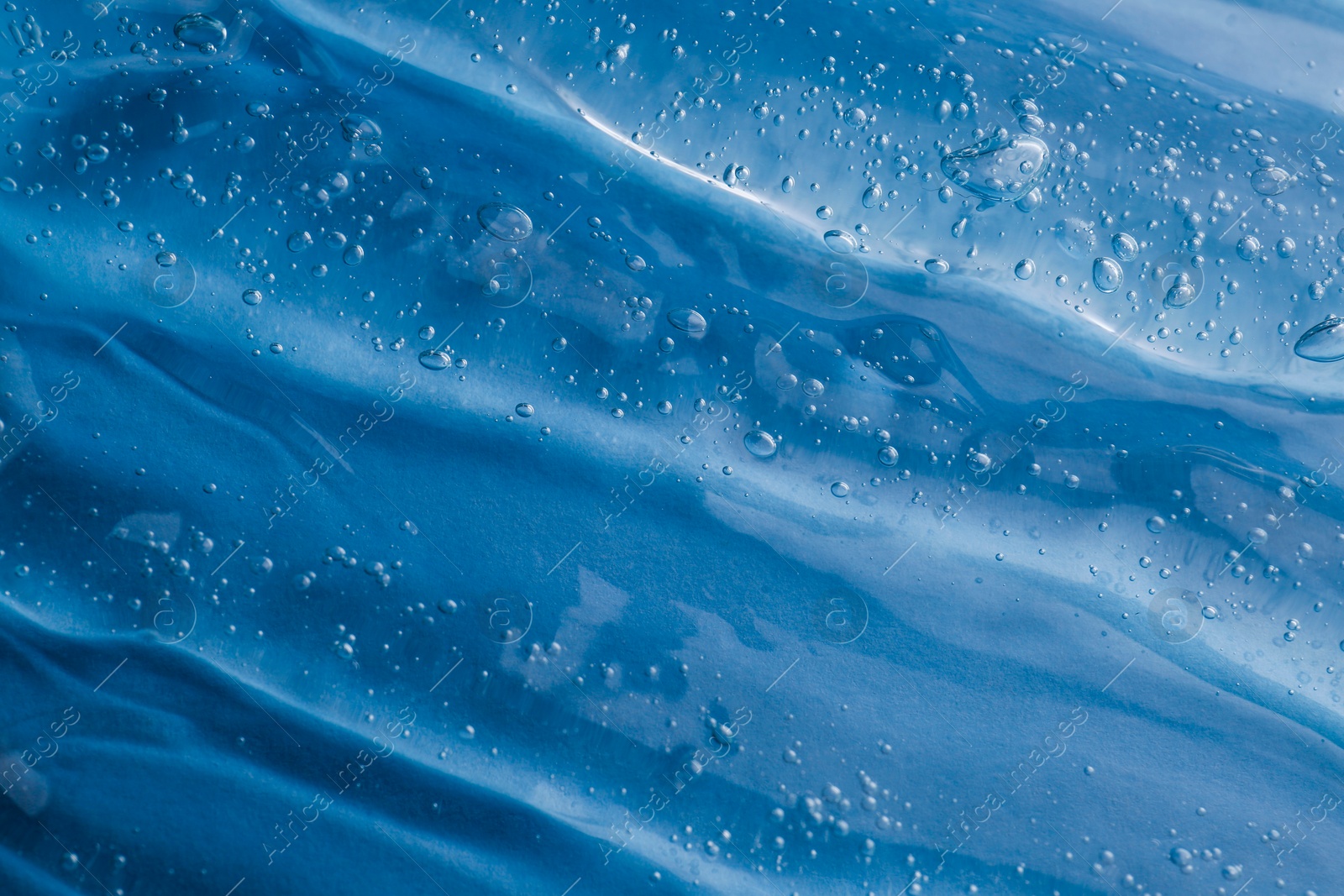 Photo of Texture of light blue shower gel as background, top view