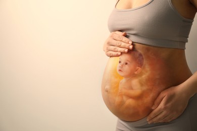 Pregnant woman and baby on beige background, closeup view of belly. Double exposure