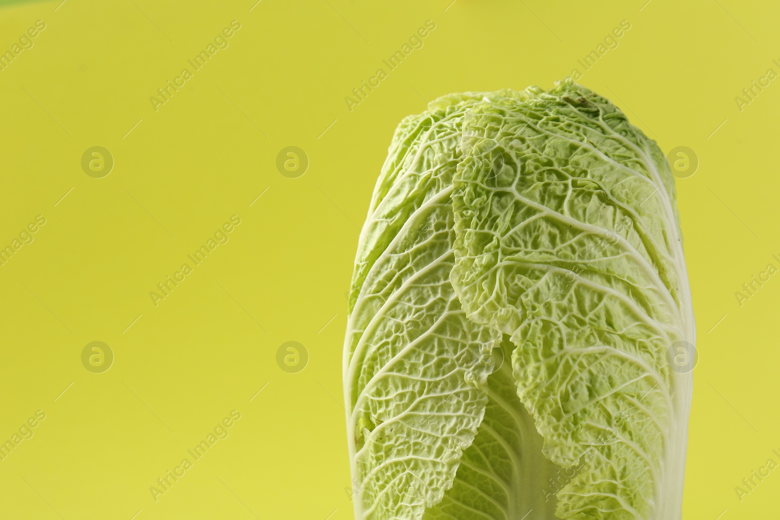 Photo of Fresh ripe Chinese cabbages on pale yellow background, closeup. Space for text