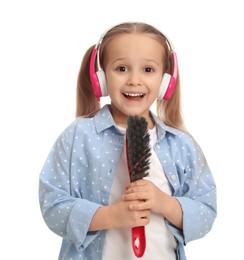 Photo of Cute little girl in headphones with brush singing on white background