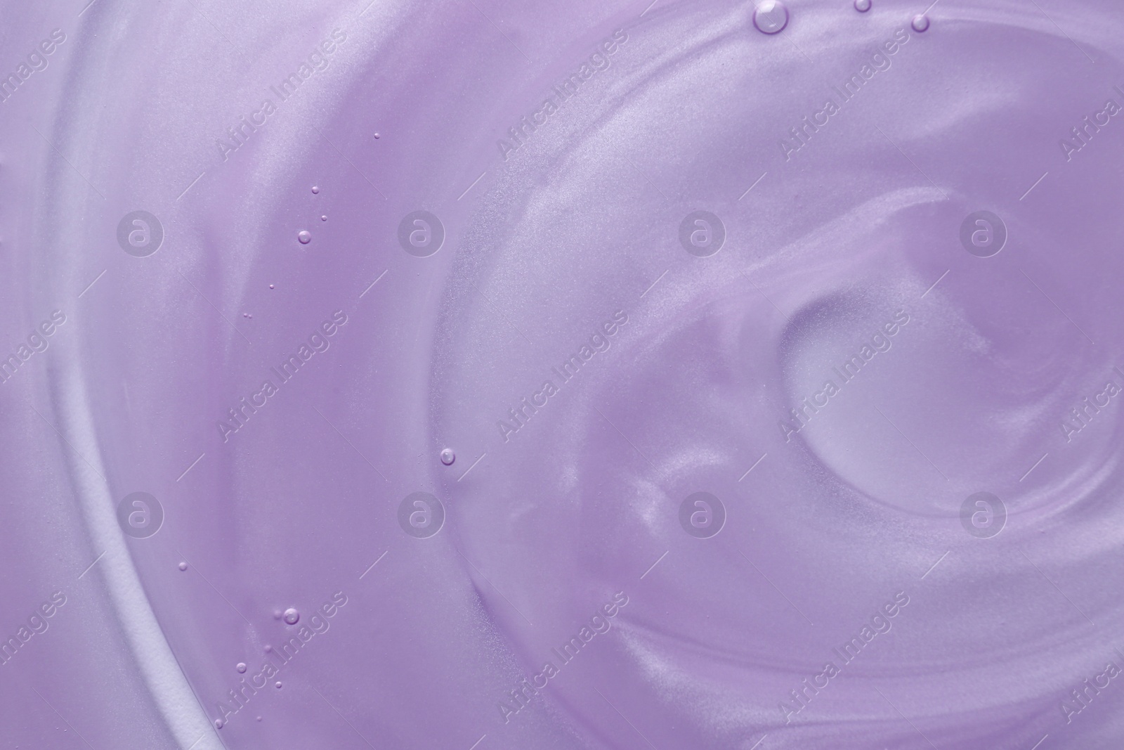 Photo of Sample of violet shower gel on white background, closeup