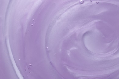 Photo of Sample of violet shower gel on white background, closeup