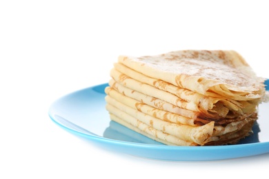 Stack of tasty thin folded pancakes on plate against white background