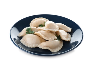 Photo of Plate of tasty dumplings served with parsley on white background