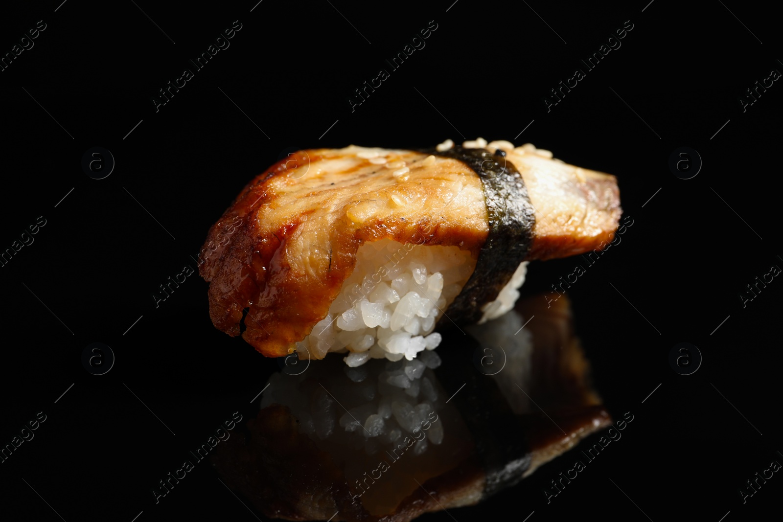 Photo of Delicious sushi with smoked eel on black background