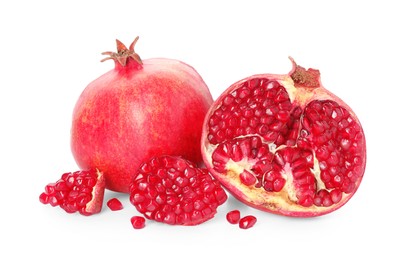 Half and whole pomegranates isolated on white