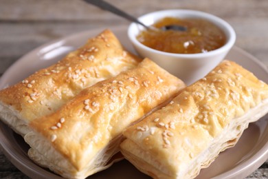 Photo of Delicious puff pastry served on table, closeup