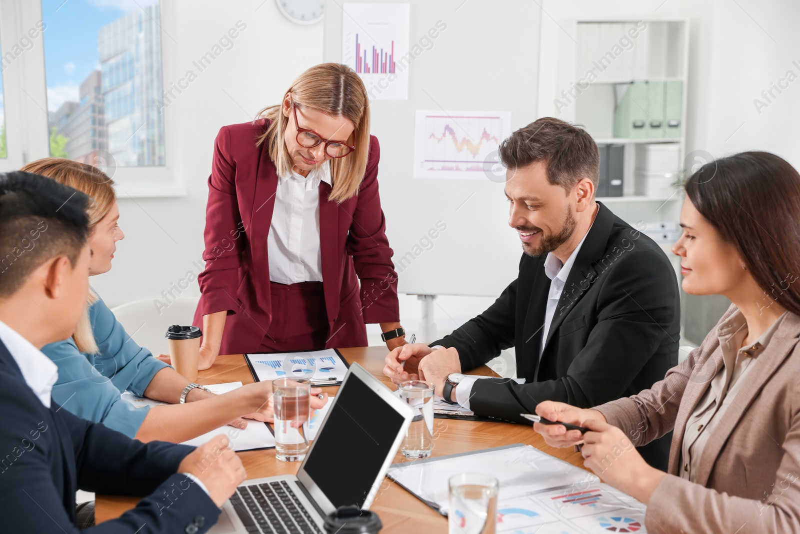 Photo of Businesswoman having meeting with her employees in office