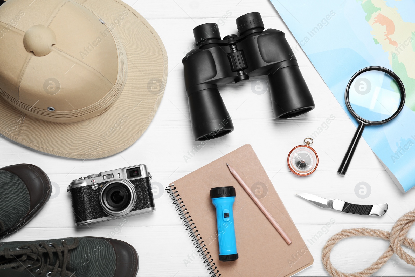 Photo of Flat lay composition with different safari accessories on white wooden background