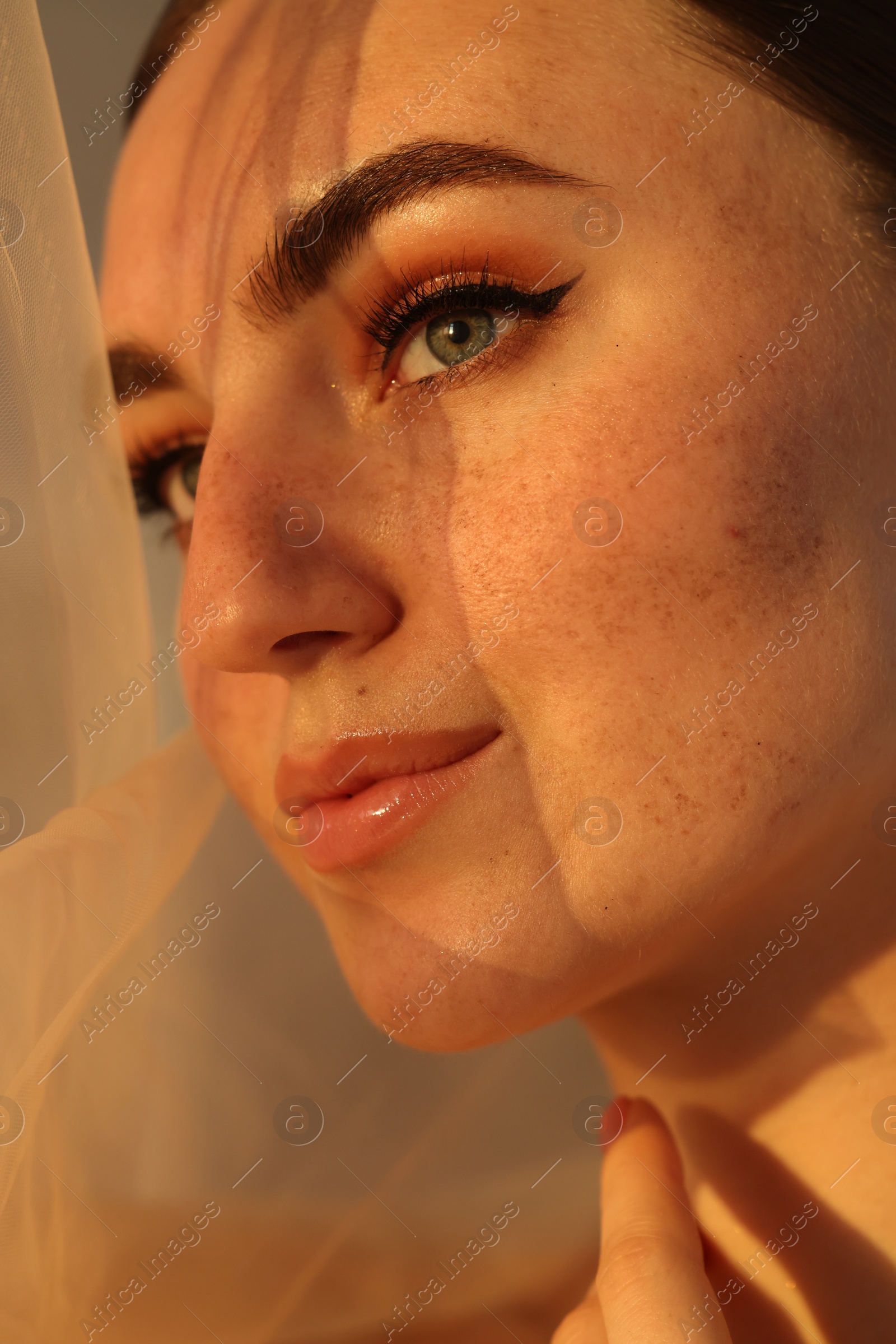 Photo of Fashionable portrait of beautiful woman with fake freckles, closeup