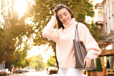 Young woman with stylish shopper bag outdoors