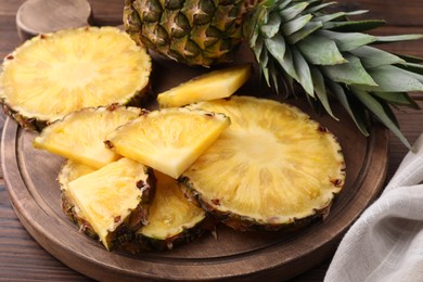 Photo of Pieces of tasty ripe pineapple on table, closeup