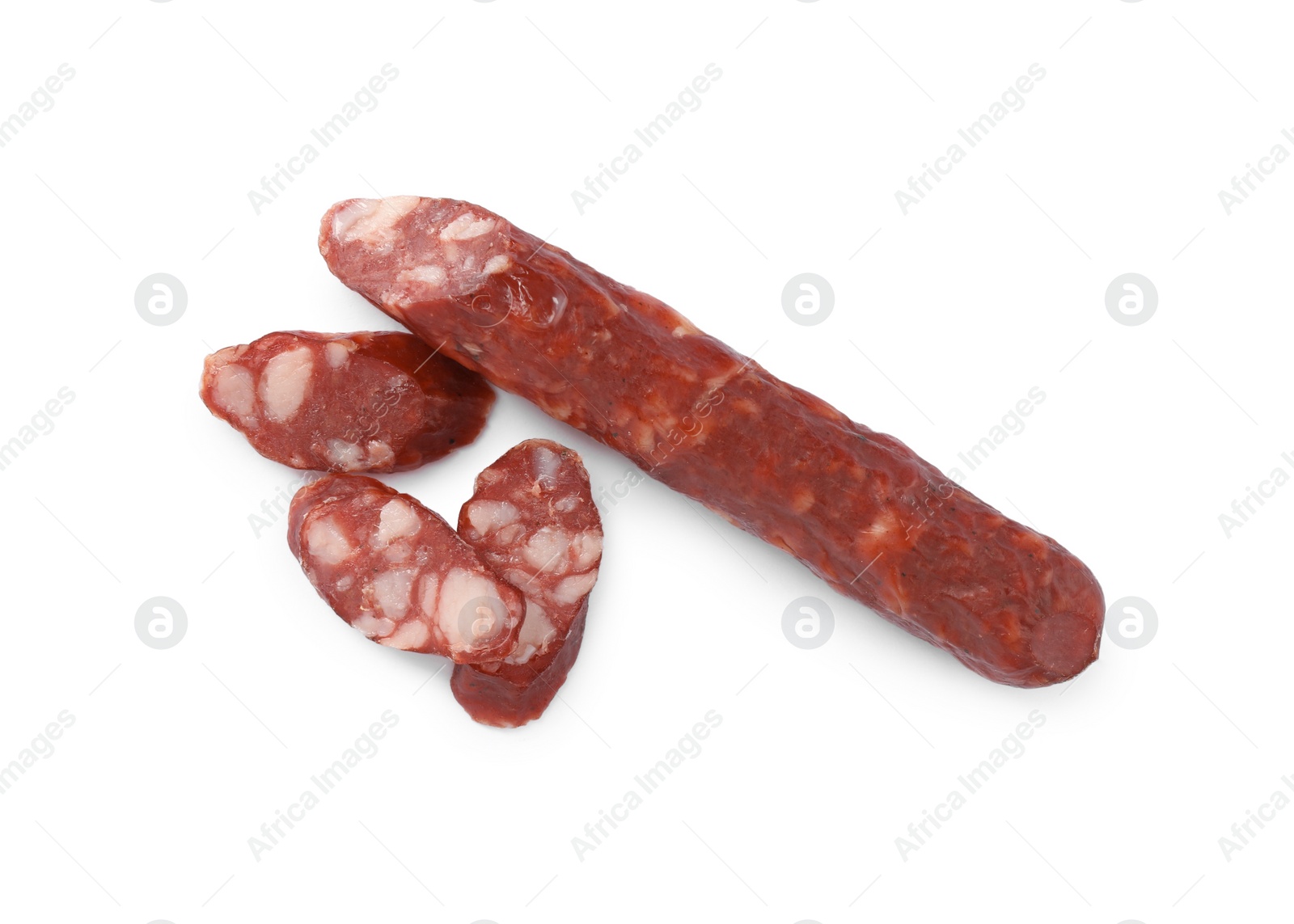 Photo of Thin dry smoked sausages isolated on white, top view