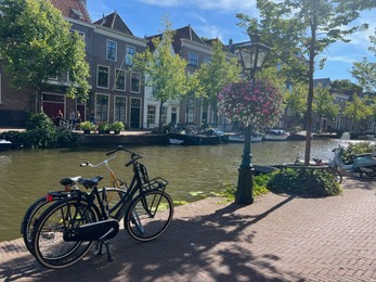 Photo of Leiden, Netherlands - August 03, 2022: View of city street with buildings along canal