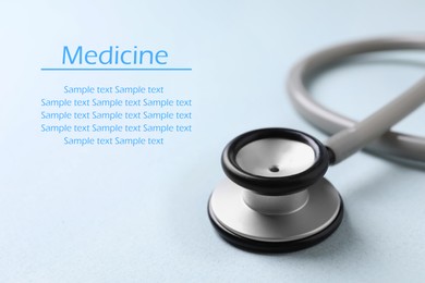 Stethoscope on light blue background. Space for text