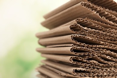 Photo of Stack of cardboard for recycling on blurred background, closeup